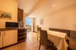 a kitchen and dining room with a table and chairs at Residence Kronstein - Fewo 2 in Tesimo