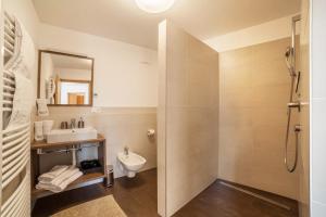 a bathroom with a shower and a sink and a toilet at Flatschhof - Apartment Vermoi in Kastelbell-Tschars +13 photos