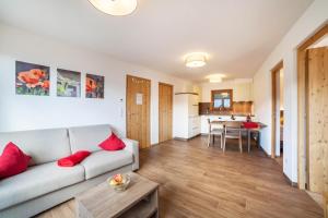 a living room with a couch and a table at Flatschhof - Apartment Vermoi in Kastelbell-Tschars