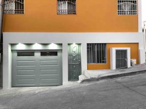 two garage doors on the side of a building at Departamento privado in Tijuana