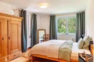 a bedroom with a bed and a large window at Maierhof 341 in See