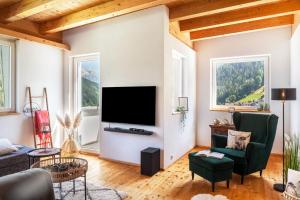 a living room with a large flat screen tv at Maierhof 341 in See