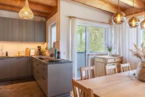 a kitchen and dining room with a table and chairs at Maierhof 341 in See