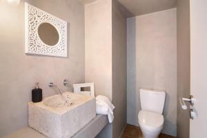 a bathroom with a sink and a toilet at Casa Loulé in Loulé