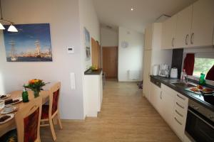 a kitchen with a table and a dining room at Ferienhaus Nixe7 in Dorum Neufeld
