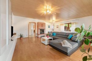 a large living room with a couch and a tv at Fewo Lora in Blankenrath