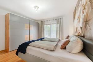 a bedroom with a bed and a window at Fewo Lora in Blankenrath