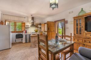 a kitchen with a table and chairs and a refrigerator at La Terrera in Órgiva