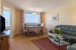 a living room with a couch and a table at Sylter Residenz Westerland in Westerland