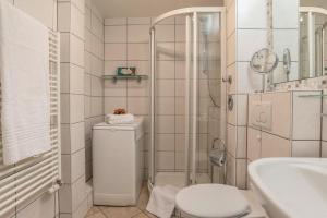 a bathroom with a shower and a toilet and a sink at Sylter Residenz Westerland in Westerland +23 photos