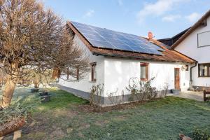 a white house with solar panels on the roof at Ferienhaus Landliebe in Ötisheim