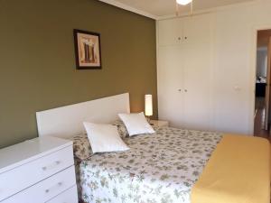 a bedroom with a bed with two pillows on it at Nereidas Beachfront in Cullera +21 photos