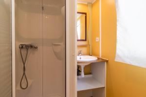 a bathroom with a shower and a sink at Mobilhome Le Tilleul in Saint-Pompont +12 photos