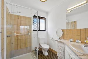 a bathroom with a toilet and a shower and a sink at Casa Bella in Bongaree +25 photos