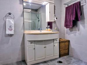 a bathroom with a sink and a mirror at Beach panorama Caleta in Caleta De Velez +32 photos