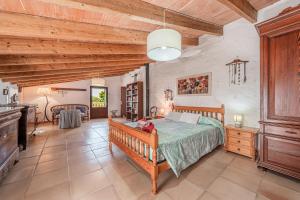a bedroom with a bed in a room with wooden ceilings at Ca S'hereu in Felanitx