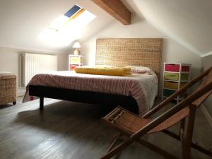 a bedroom with a bed and a chair at Le Kiosque de Compostelle in Espaly-Saint-Marcel +8 photos