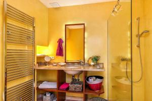 a yellow bathroom with a sink and a shower at Casa Maria Angela in Artá +10 photos