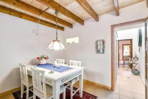 a dining room with a white table and chairs at Casa Maria Angela in Artá