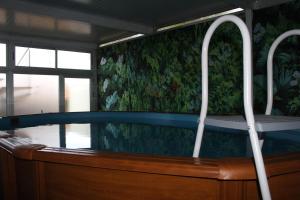 a bath tub in a room with a window at D'ouro Prestige Relax in Sanfins do Douro