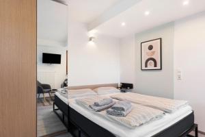 a bedroom with a bed with towels on it at Ferienhaus Landliebe in Ötisheim