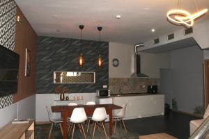 a kitchen and dining room with a table and chairs at D'ouro Prestige Relax in Sanfins do Douro