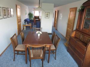 a dining room with a wooden table and chairs at Ferienwohnung Hoffarth 1 in Gelting