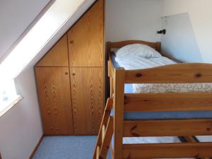 a bedroom with two bunk beds and a staircase at Ferienwohnung Hoffarth 1 in Gelting