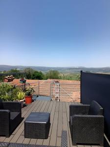 a patio with chairs and a table on a deck at D'ouro Prestige Relax in Sanfins do Douro