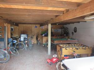 a garage with bikes parked in a room with a table at Ferienwohnung Hoffarth 1 in Gelting