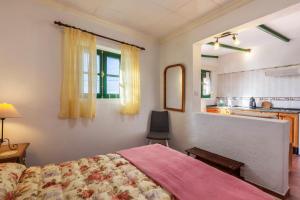 a bedroom with a bed and a table and a kitchen at Casa Victor - Apartment 4 in La Orotava