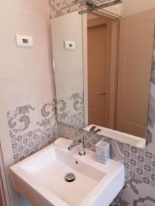 a bathroom with a white sink and a mirror at Il Cisto in Marciana