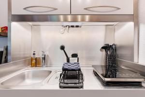 a kitchen counter with a sink and a stove at Gutenburgturm 18qm auf 3 Etagen in Waldshut-Tiengen