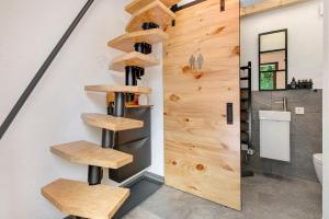 a staircase in a bathroom with wooden shelves at Gutenburgturm 18qm auf 3 Etagen in Waldshut-Tiengen +26 photos
