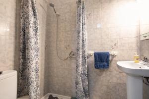 a bathroom with a shower with a toilet and a sink at Casa Fefa in Candelaria +29 photos