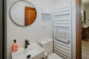 a white bathroom with a sink and a mirror at El Corcal in Triollo +27 photos