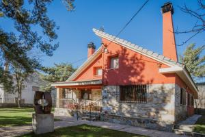 an orange house with a chimney on top at El Corcal in Triollo