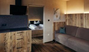 a living room with a couch and a bed at Obertimpflerhof Wohnung Rosi in Verano