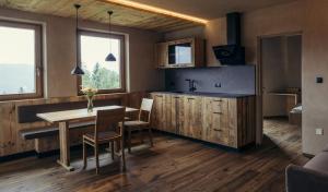 a kitchen with a table and chairs and a sink at Obertimpflerhof Wohnung Rosi in Verano +4 photos