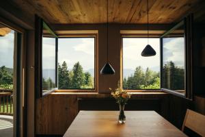 a room with windows and a table with flowers on it at Obertimpflerhof Wohnung Rosi in Verano
