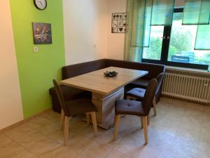 a dining room with a wooden table and chairs at Ferienwohnung Ödbach mit Terrasse in Konzell +7 photos