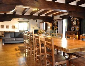 a dining room with a large wooden table and chairs at Barbenea in Oronoz-Mugaire