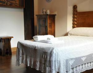 a bedroom with a bed and a table with a white blanket at Barbenea in Oronoz-Mugaire