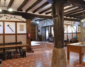 a large room with wooden beams and a table at Barbenea in Oronoz-Mugaire