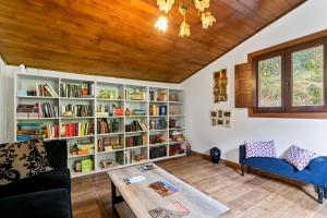 a living room with a book shelf filled with books at El Bosque in Candamin