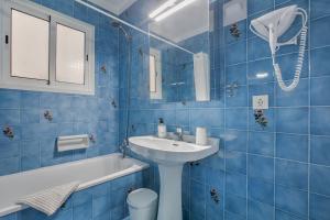 a blue tiled bathroom with a sink and a toilet at Vv Tamara Sunset Suite in Tacoronte +24 photos