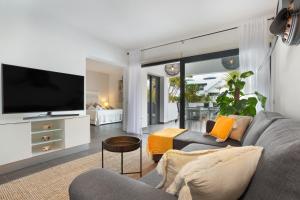 a living room with a couch and a tv at vv Infinity Casilla in La Oliva