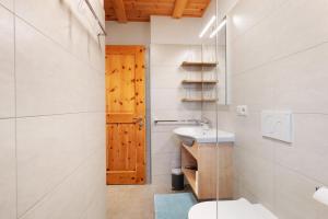 a bathroom with a toilet and a sink at Almhaus Morgenrast in Sarntal +82 photos