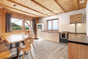 a kitchen with a table and chairs in a room at Almhaus Morgenrast in Sarntal