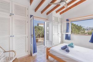a bedroom with a bed and a window at Ses Roques Casa del Sol in Illes Balears